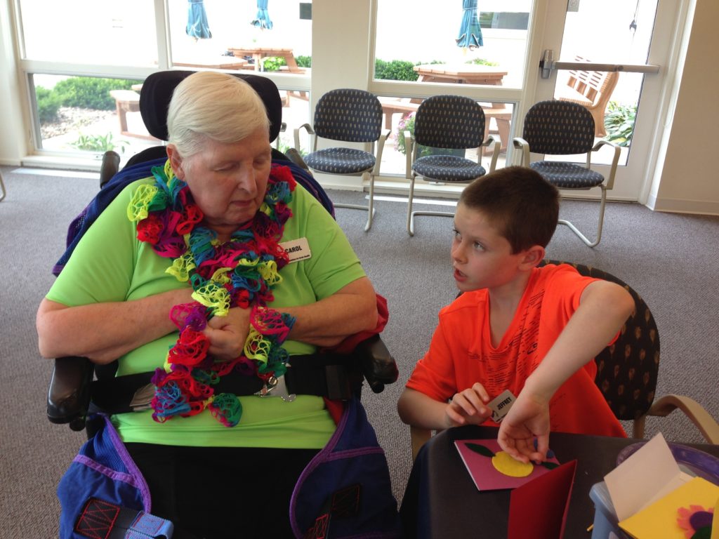 Person with dementia with grandchild making cards